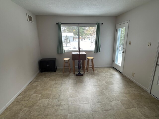 dining room featuring a textured ceiling