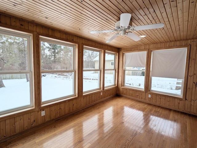 unfurnished sunroom with wooden ceiling and ceiling fan