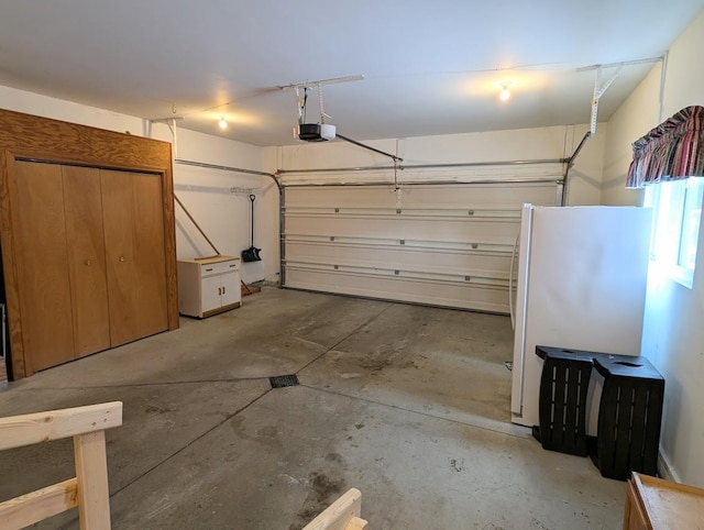 garage featuring a garage door opener and white fridge