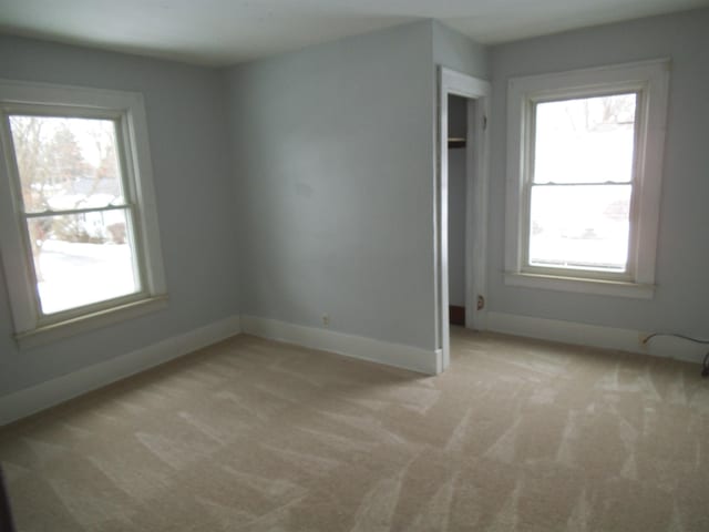 carpeted empty room with a healthy amount of sunlight