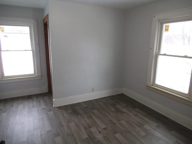 spare room with dark hardwood / wood-style flooring