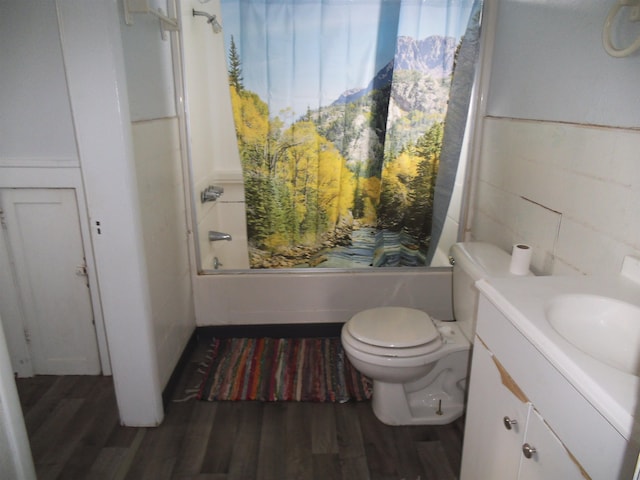 full bathroom featuring tile walls, vanity, wood-type flooring, shower / washtub combination, and toilet