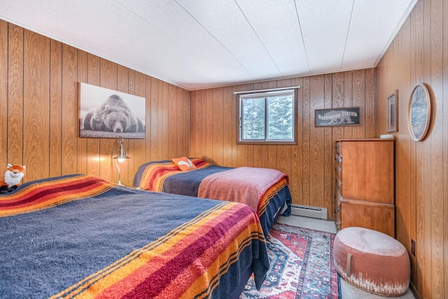 bedroom featuring a baseboard radiator and wood walls