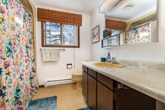 bathroom featuring vanity, ornamental molding, a healthy amount of sunlight, and baseboard heating