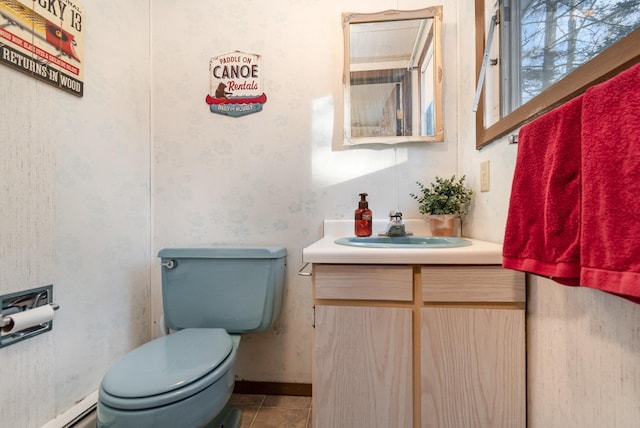 bathroom featuring baseboard heating, tile patterned floors, toilet, and vanity