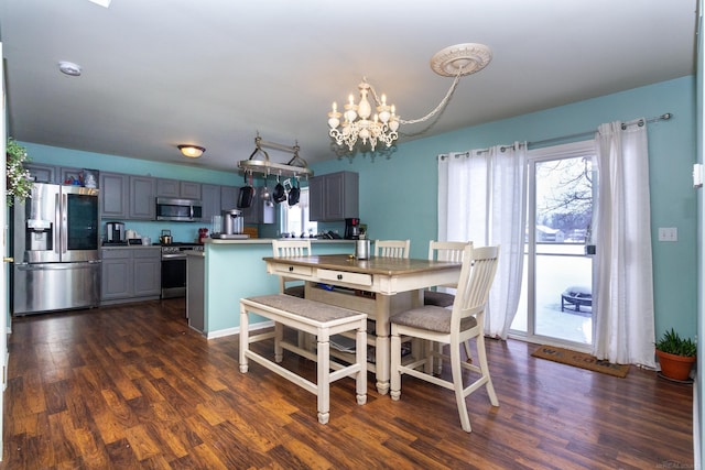 dining room featuring dark hardwood / wood-style floors and an inviting chandelier