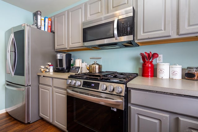 kitchen with white cabinetry, dark hardwood / wood-style floors, and appliances with stainless steel finishes