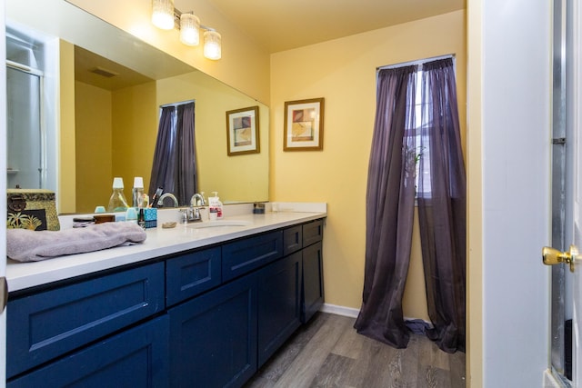 bathroom featuring wood-type flooring and vanity