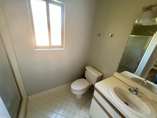 bathroom with a shower with door, vanity, plenty of natural light, and toilet