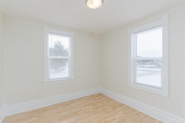 unfurnished room with light wood-type flooring