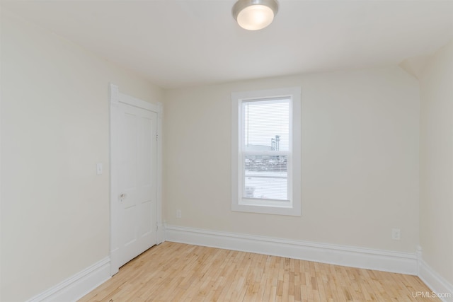 empty room with light hardwood / wood-style flooring