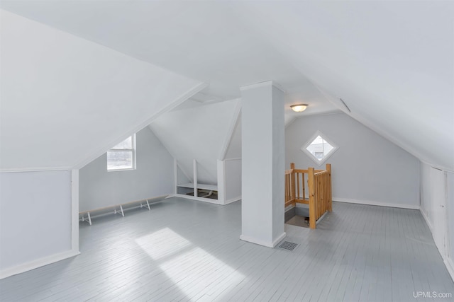 bonus room with vaulted ceiling and hardwood / wood-style floors