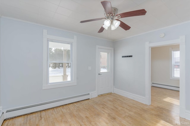 unfurnished room with a baseboard radiator, a wealth of natural light, and light wood-type flooring