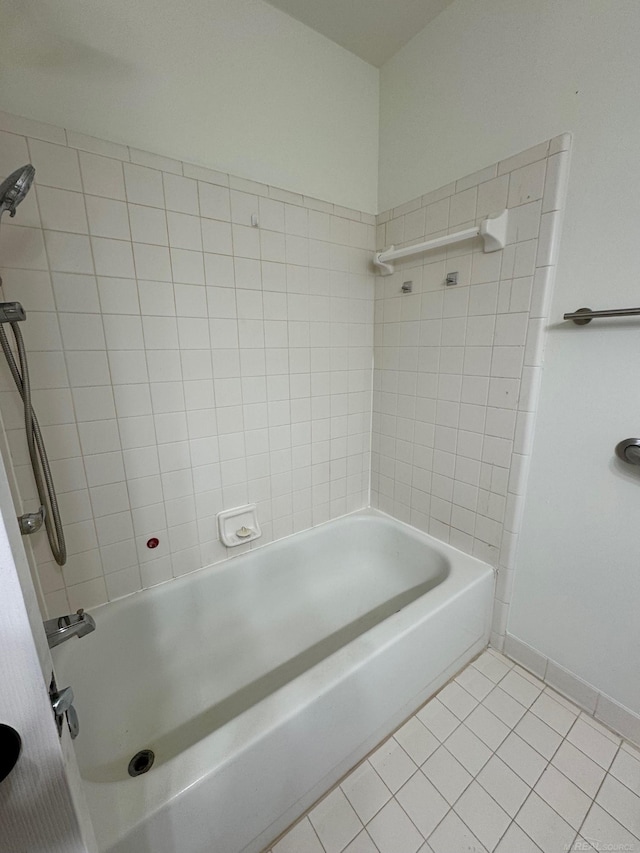 bathroom featuring tile patterned flooring and tiled shower / bath