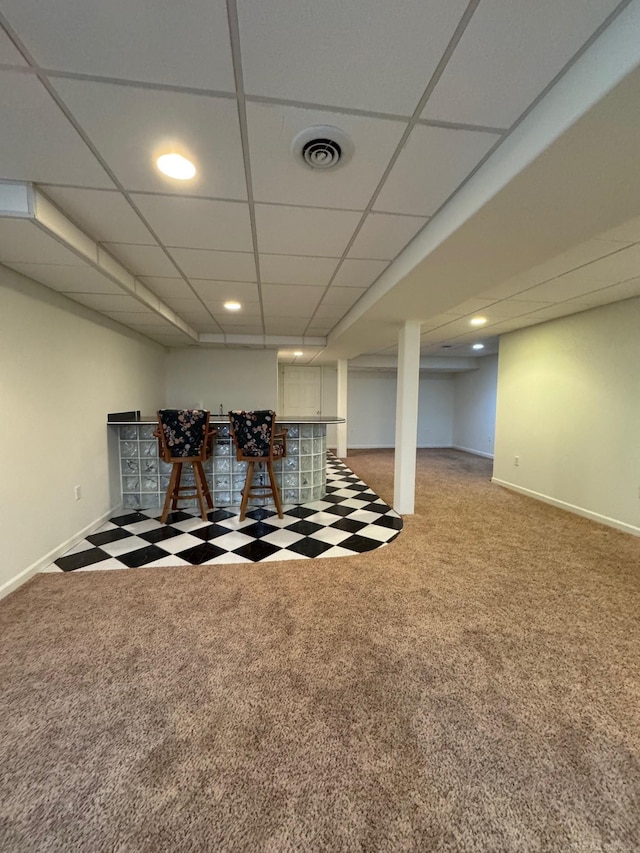 interior space with carpet floors and a drop ceiling