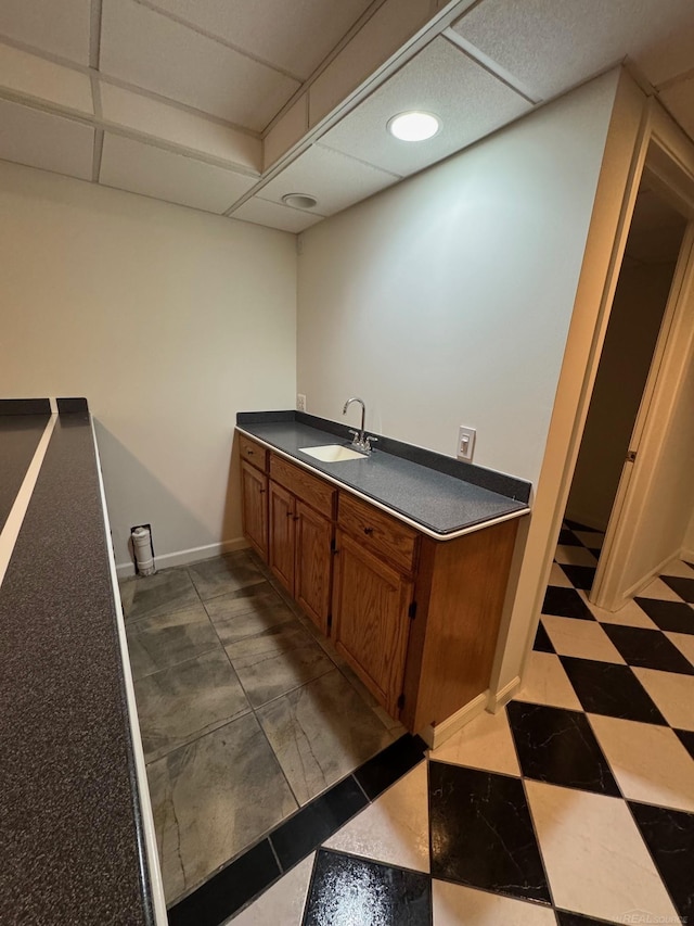 kitchen with sink and a drop ceiling