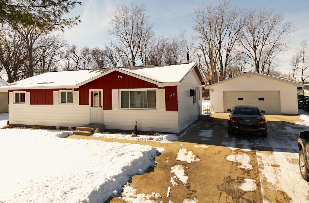 single story home with an outbuilding and a garage