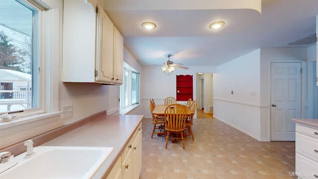 dining area with ceiling fan, plenty of natural light, and sink