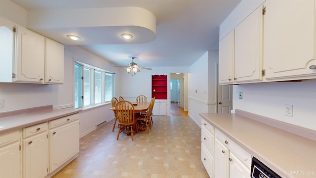 kitchen featuring white cabinetry, dishwashing machine, and ceiling fan