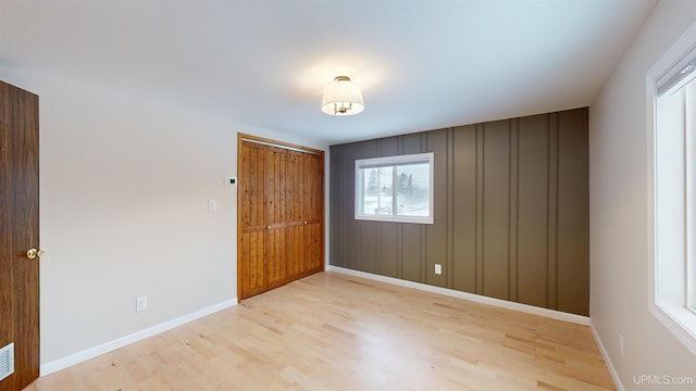 unfurnished bedroom featuring light wood-type flooring