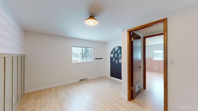 empty room featuring light hardwood / wood-style flooring and a healthy amount of sunlight