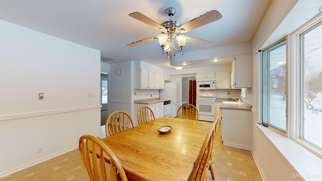 dining room featuring sink and ceiling fan