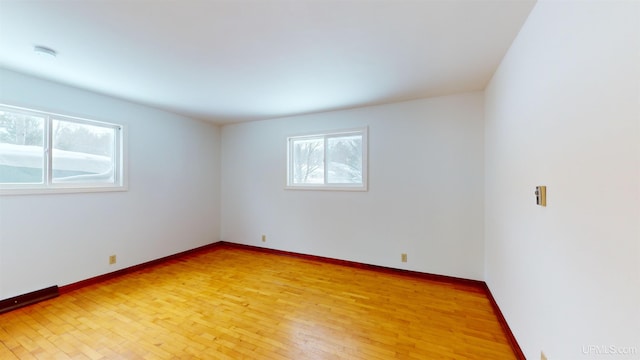 unfurnished room with light hardwood / wood-style floors