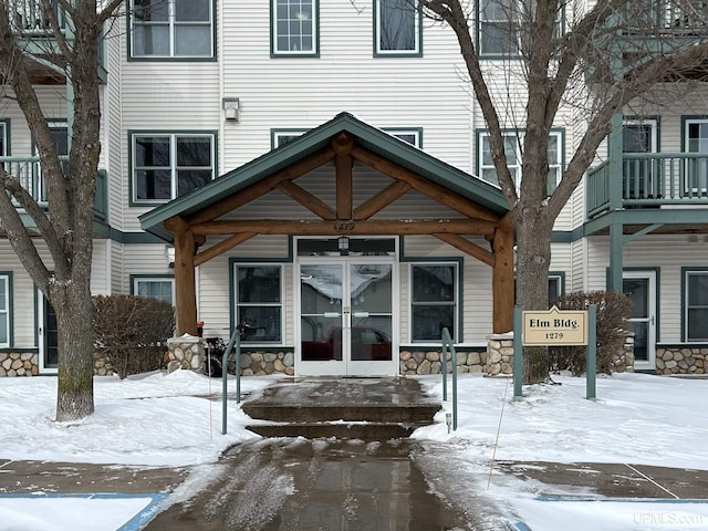 view of snow covered property entrance