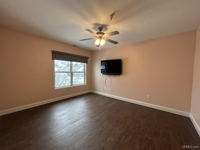 empty room with dark wood-type flooring and ceiling fan