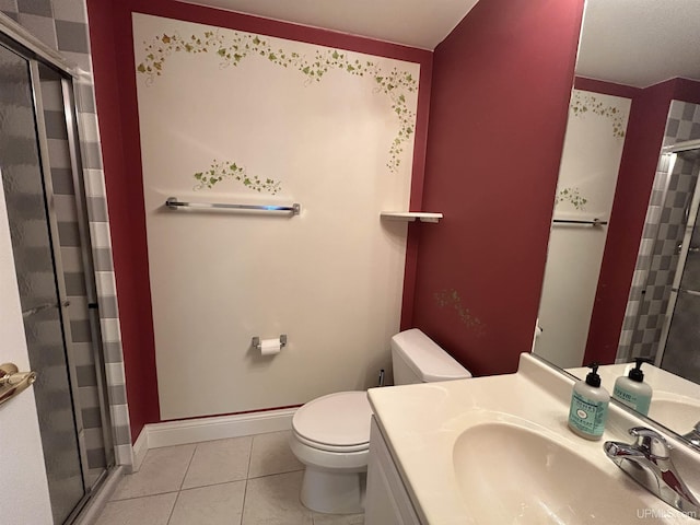 bathroom featuring vanity, a shower with door, tile patterned floors, and toilet