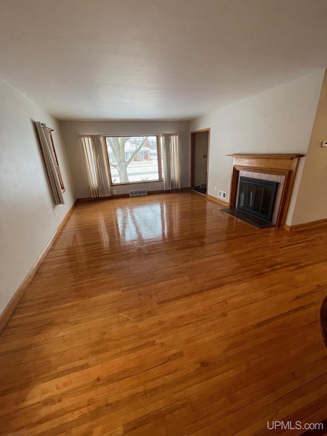 unfurnished living room featuring hardwood / wood-style floors