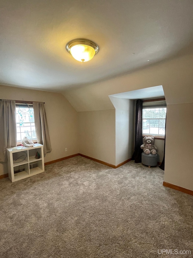 bonus room featuring vaulted ceiling, carpet, and a wealth of natural light