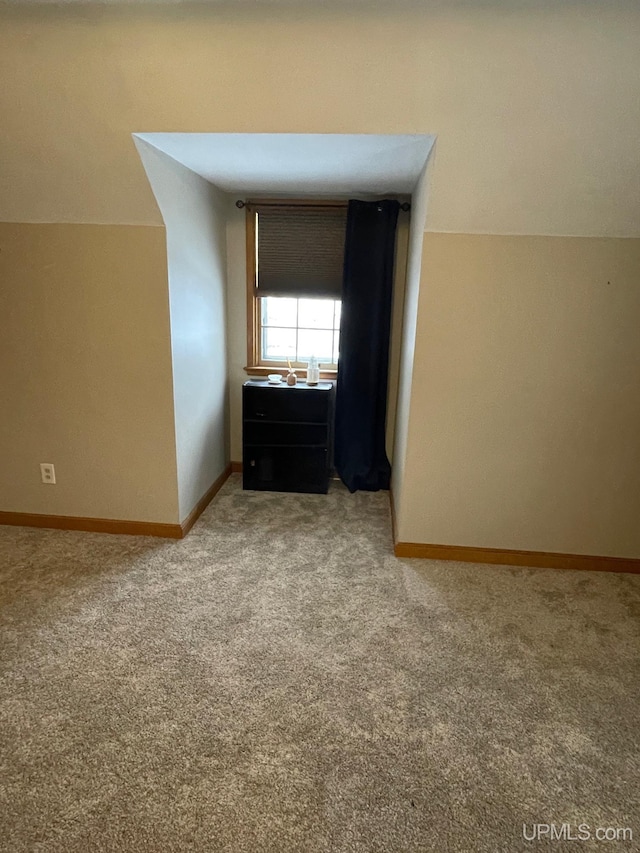 bonus room featuring carpet flooring and vaulted ceiling