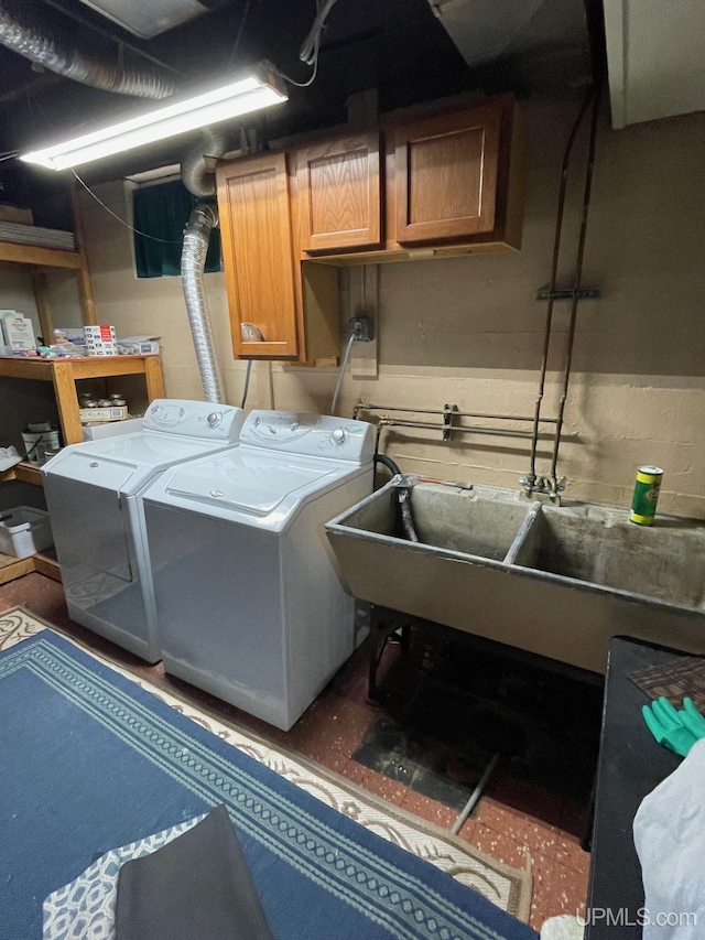 laundry room featuring washing machine and dryer and cabinets