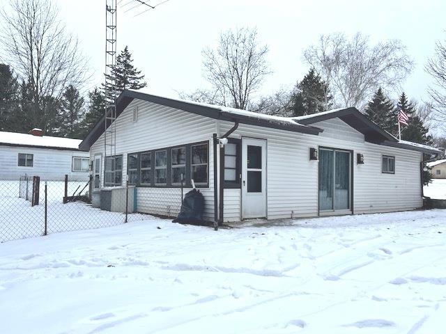 view of snow covered back of property