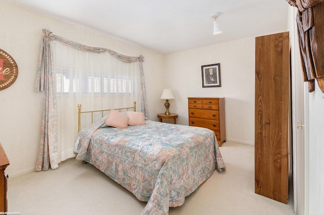 bedroom featuring light colored carpet