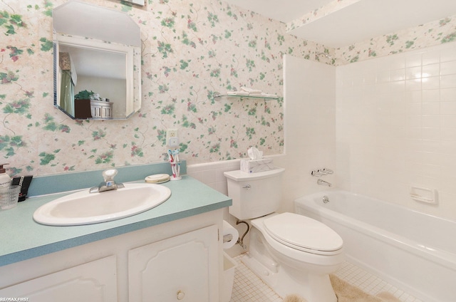 full bathroom featuring washtub / shower combination, tile patterned floors, toilet, and vanity