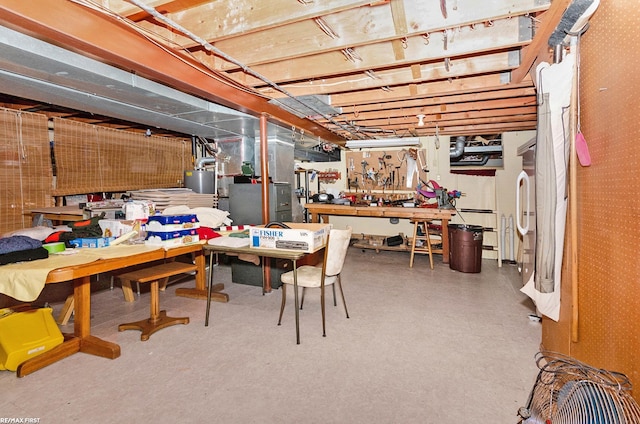 basement featuring gas water heater and a workshop area