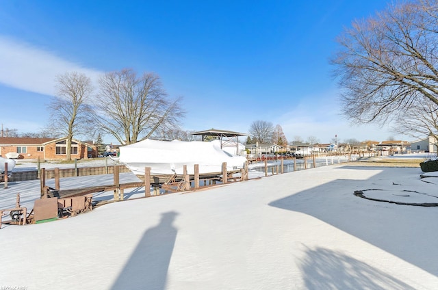 yard layered in snow featuring a boat dock