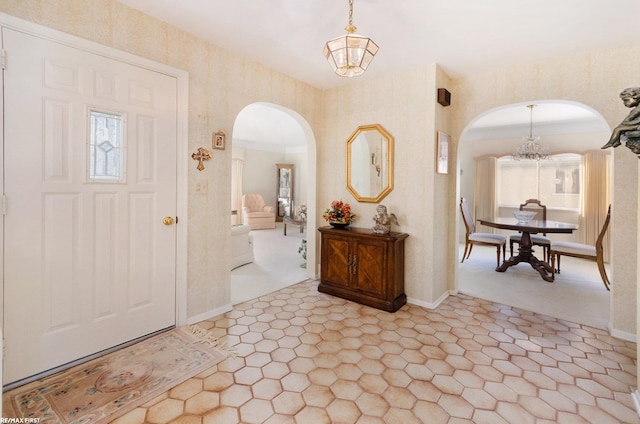 entrance foyer with plenty of natural light and a notable chandelier