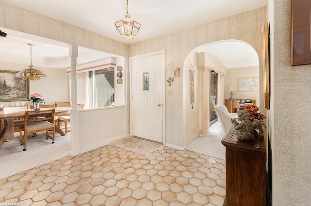 foyer entrance with a chandelier