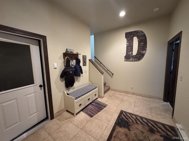 entryway featuring a baseboard heating unit and light tile patterned flooring