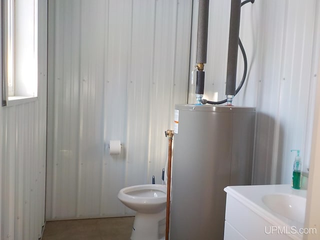 bathroom featuring gas water heater, vanity, and toilet