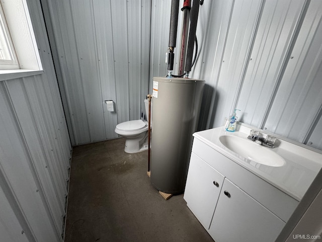 bathroom featuring toilet, vanity, concrete flooring, and gas water heater