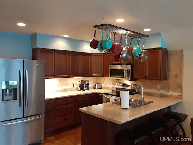 kitchen with tasteful backsplash, stainless steel appliances, and kitchen peninsula