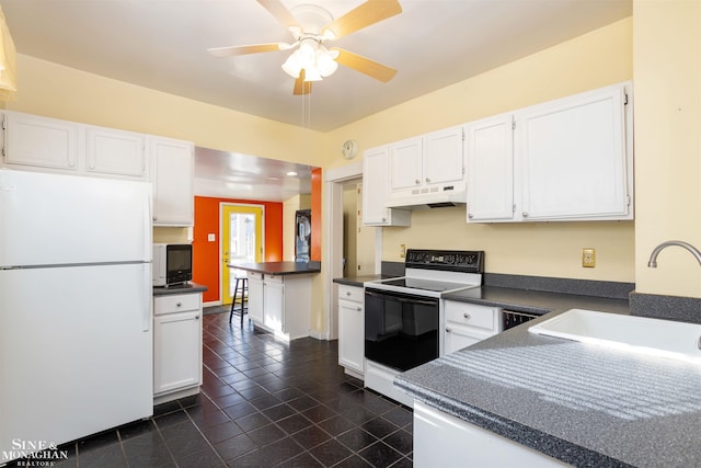 kitchen featuring white refrigerator, white cabinets, sink, and range with electric cooktop