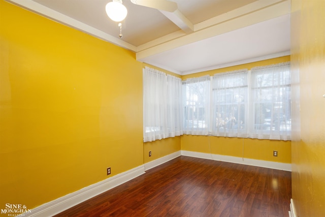 empty room featuring beam ceiling, dark hardwood / wood-style floors, and ceiling fan