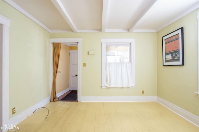 interior space with beam ceiling and hardwood / wood-style floors