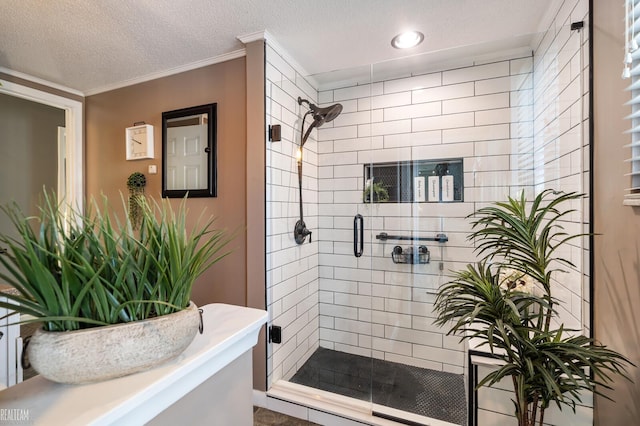 bathroom featuring a shower with door, ornamental molding, and a textured ceiling