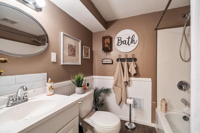 full bathroom featuring vanity, toilet, tub / shower combination, and a textured ceiling